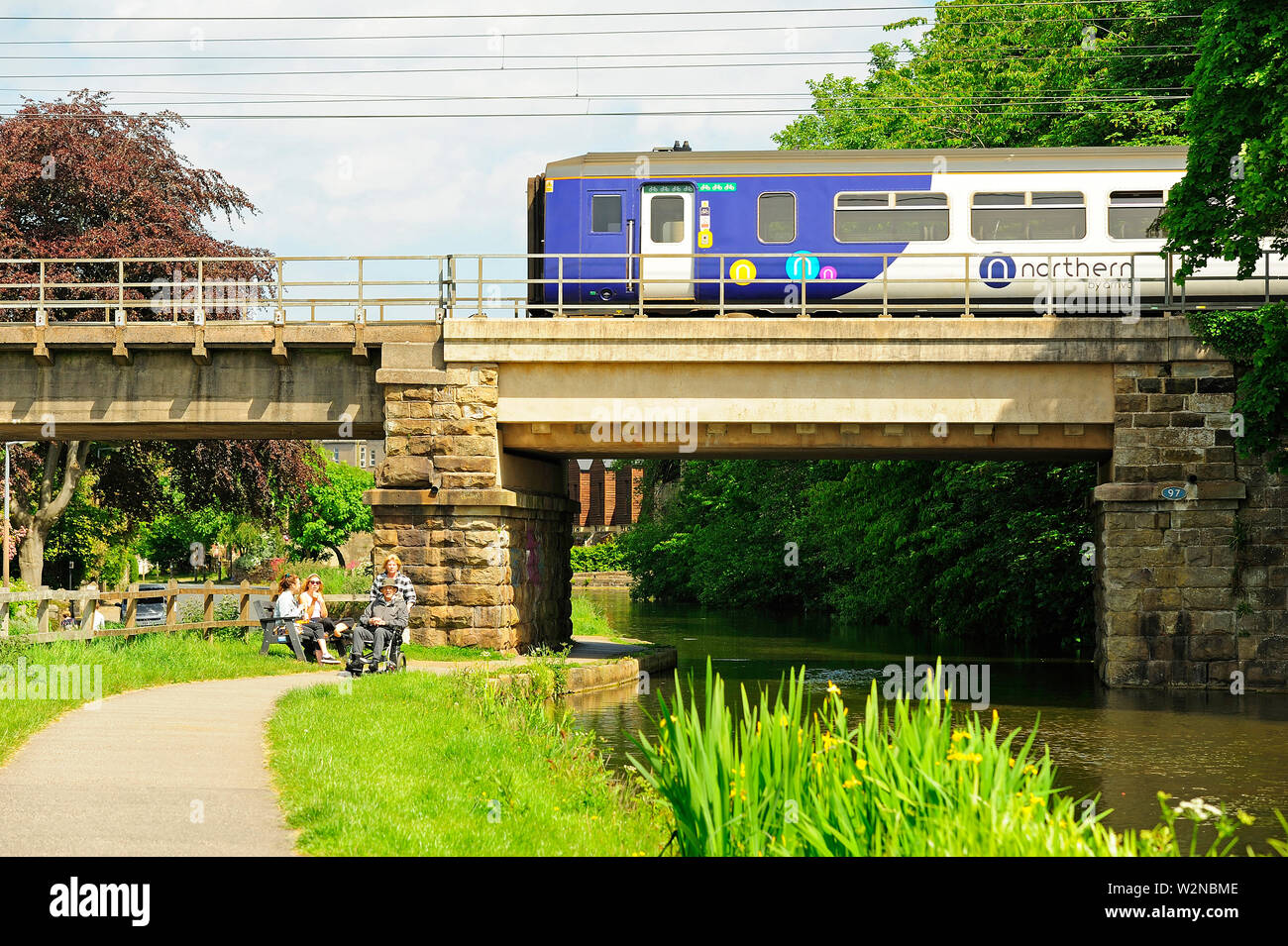 Northern Rail train on railway bridge over the Lancaster Canal at Lancaster Stock Photo