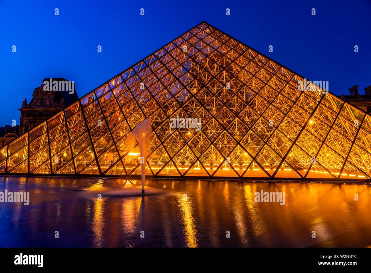 The Louvre Pyramid (Pyramide du Louvre) is a large glass and metal pyramid designed by Chinese-American architect I. M. Pei, surrounded by three Stock Photo