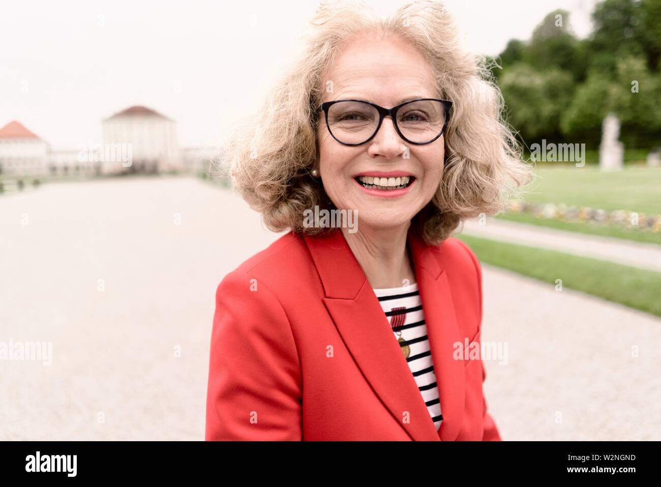 vibrant senior woman (67 years old) running outdoors in city, in  Nymphenburg, Munich, Germany Stock Photo - Alamy