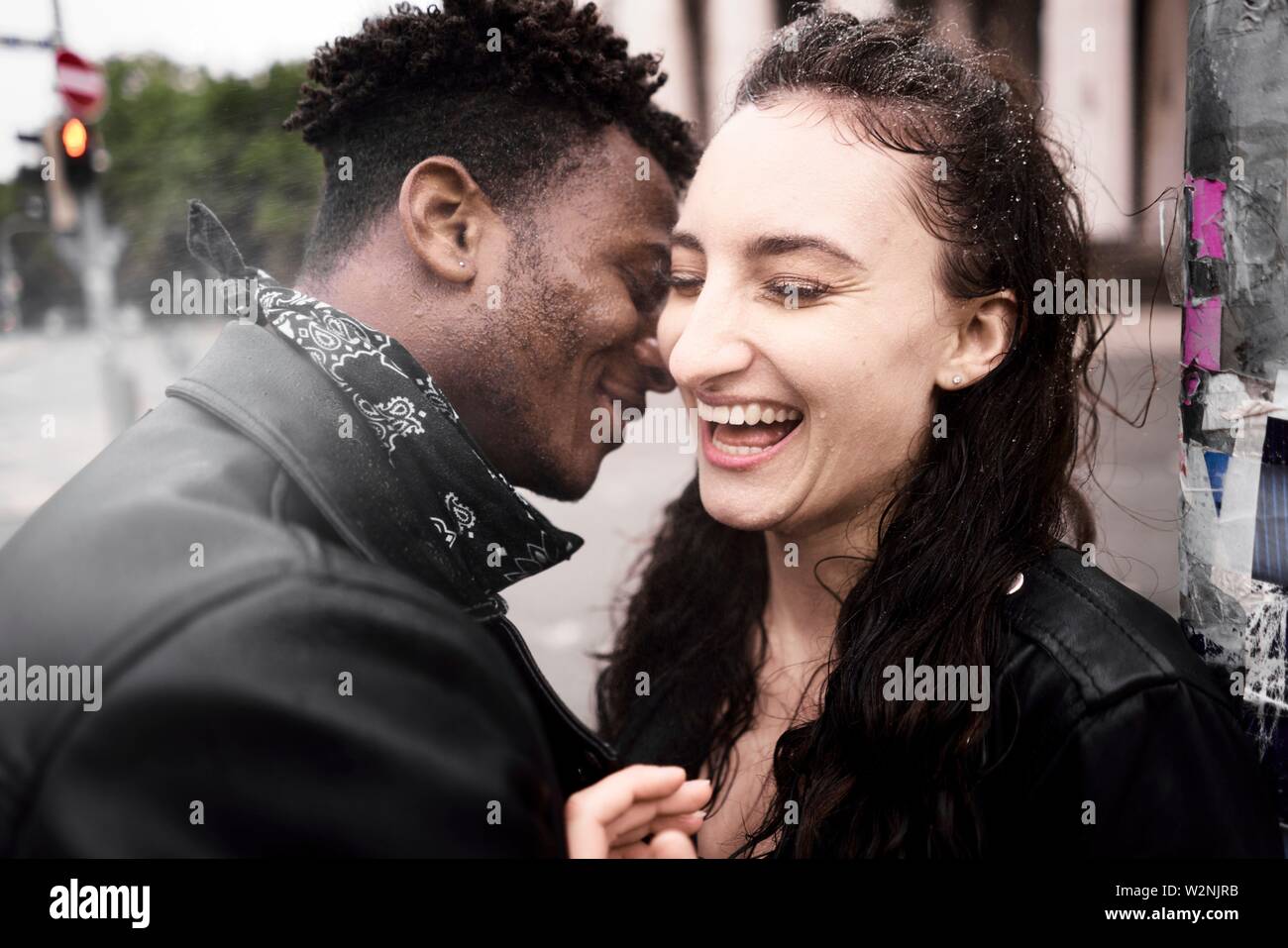happy mixed race couple at street, rainy weather, in Munich, Germany Stock Photo Alamy