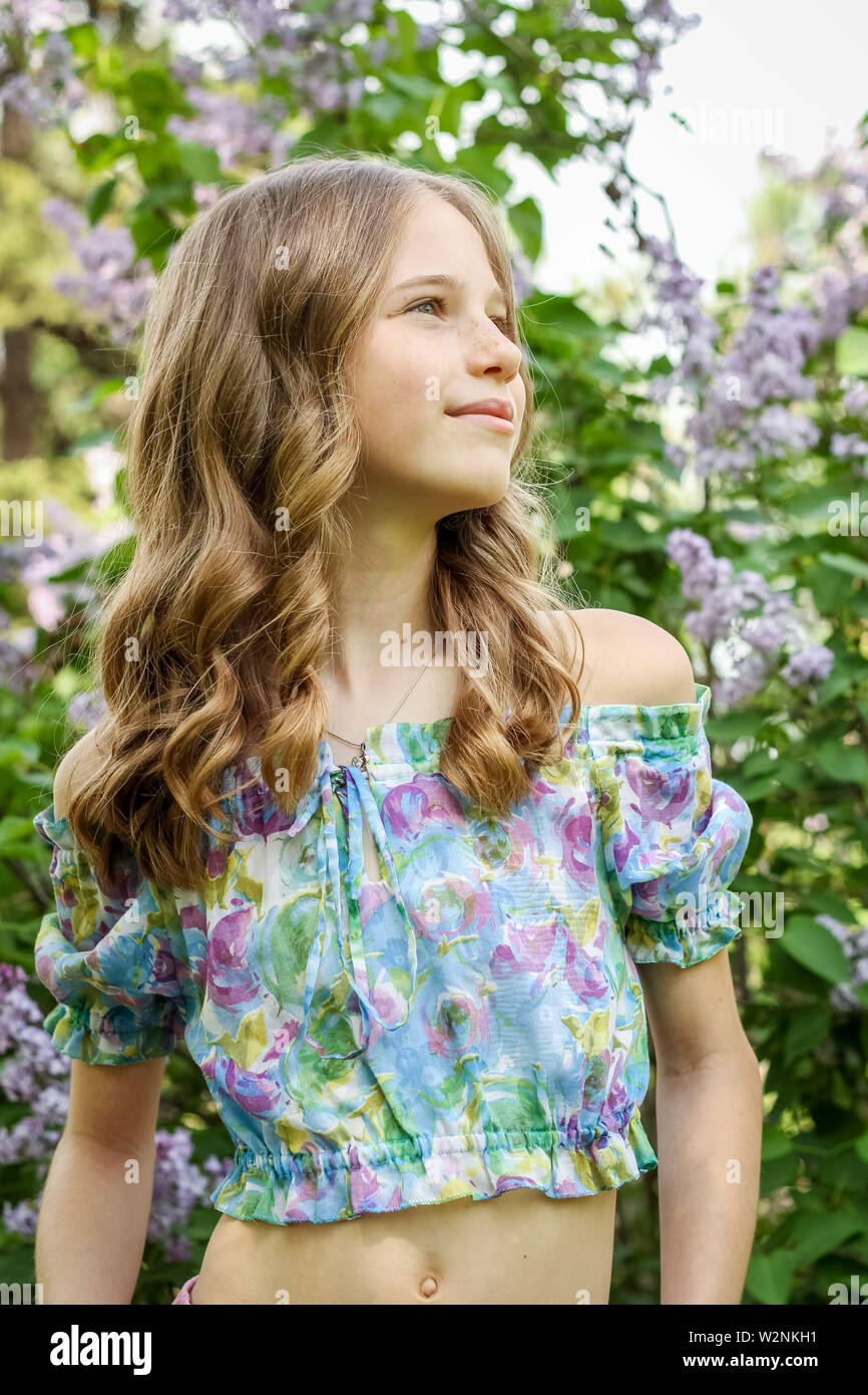 A young blonde girl in the park. Portrait of a young girl Stock Photo
