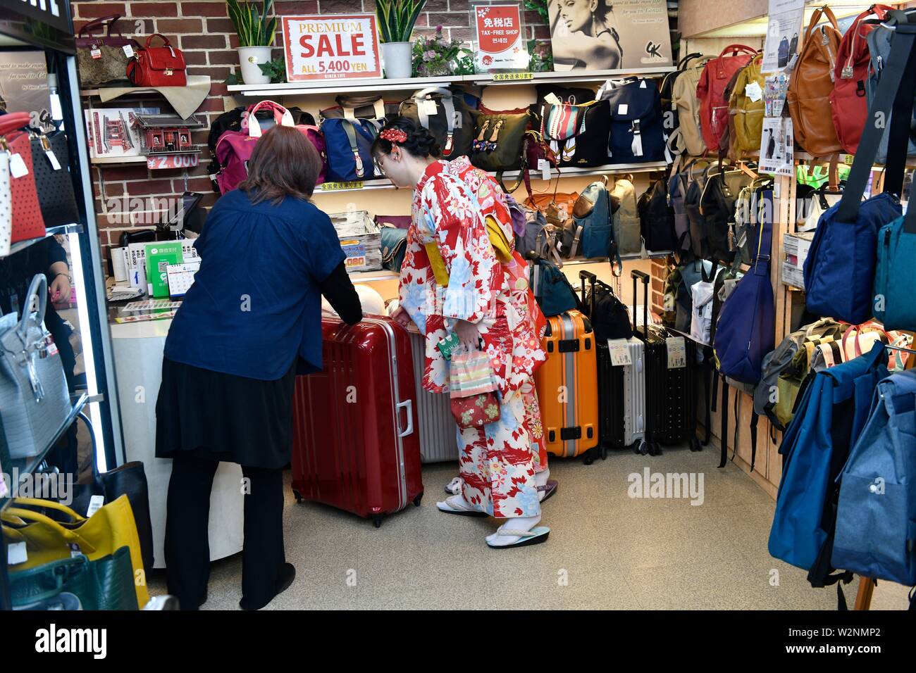 Japanese woman shopping travel suitcase in Tokyo,Japan Stock Photo Alamy