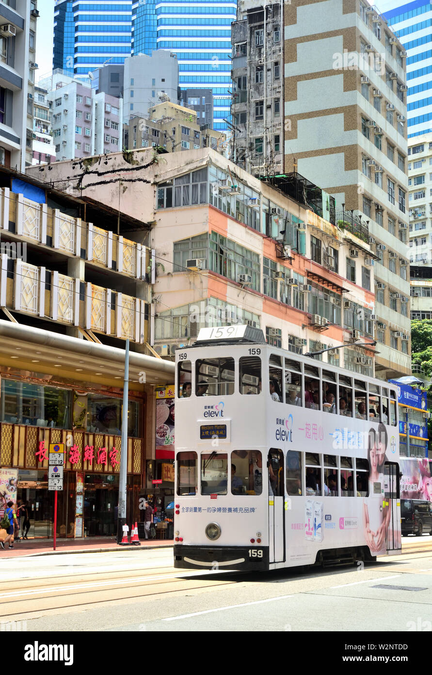 Tram running pass old buildings, Hong Kong Stock Photo