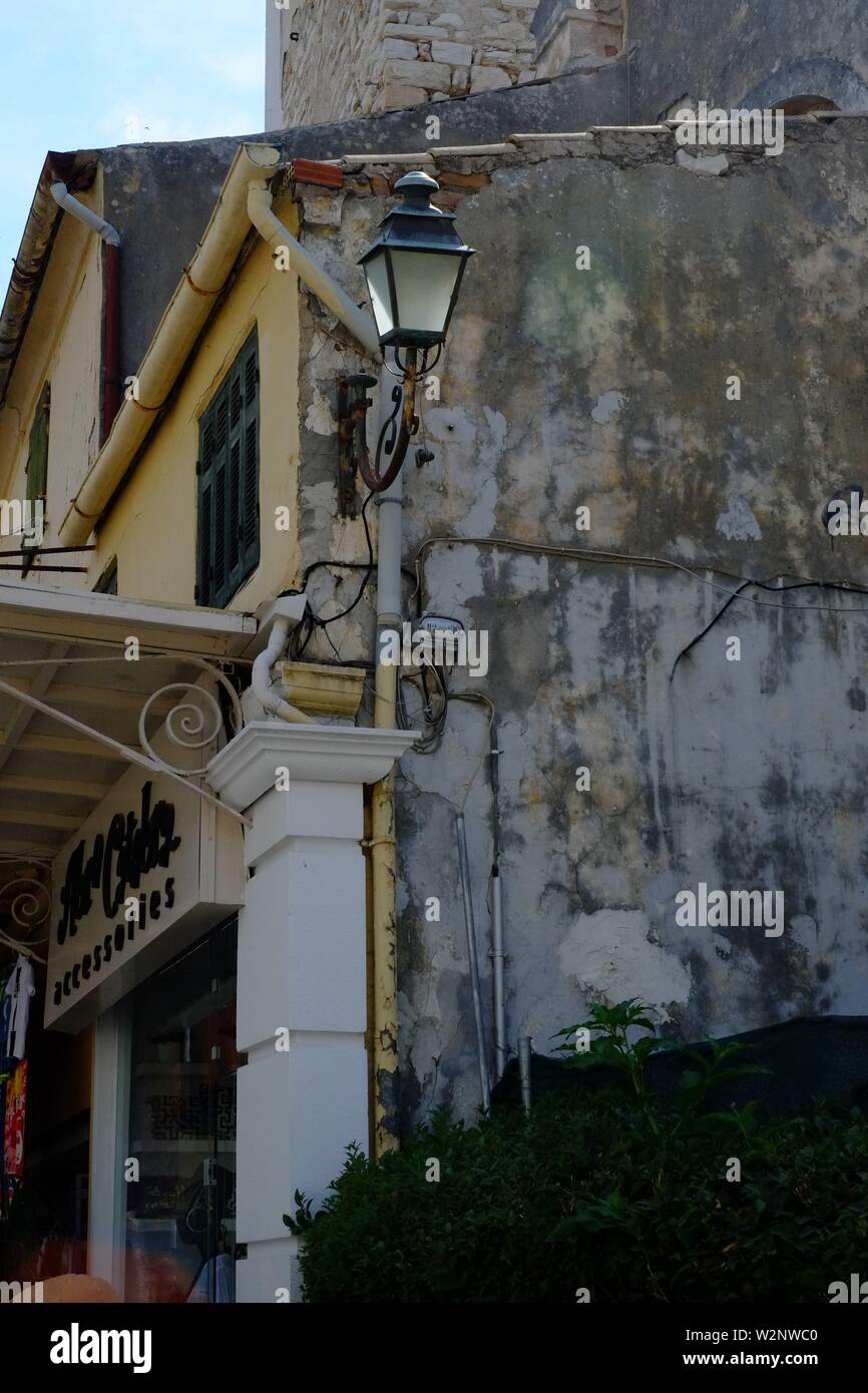 Corfu Corfu town scene deep in the shopping quarter I cam across the shot of an old apartment block.the old lamp makes the composition interesting Stock Photo