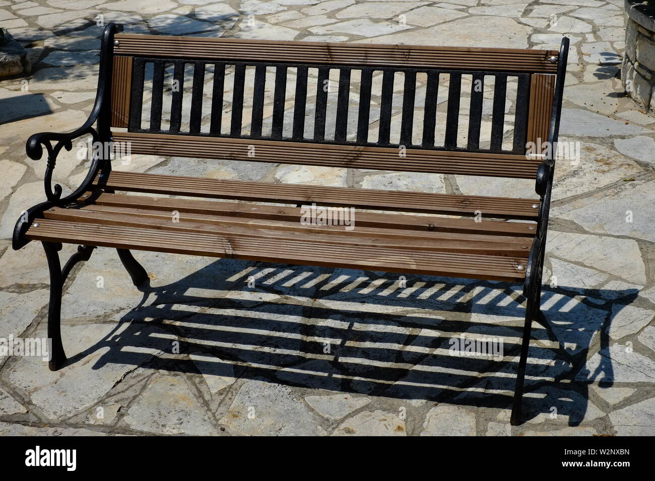 Corfu A beautiful two seated bench clean and freshly painted.A scene which all of us will have different memories some good and some not so good. Stock Photo