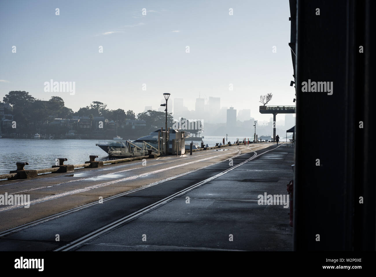 Urbanscape at Jones Bay Wharf. North Sydney visible in the through the early morning haze in the background. Sydney NSW. June 2019 Stock Photo