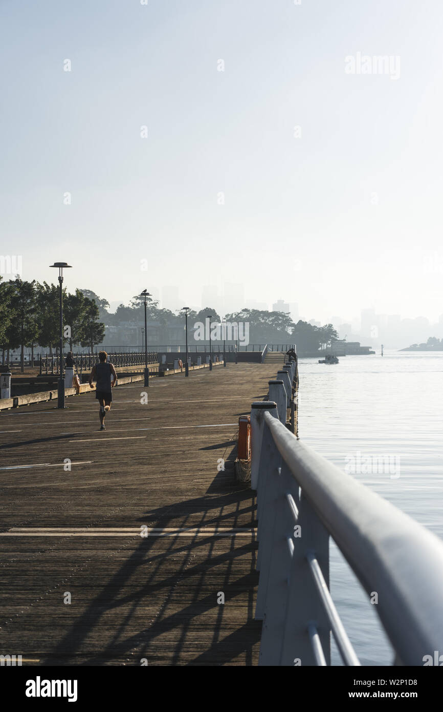 Early morning sun haze over the water at Pirrama Park/Jones Bay Wharf, Sydney NSW. June 2019 Stock Photo