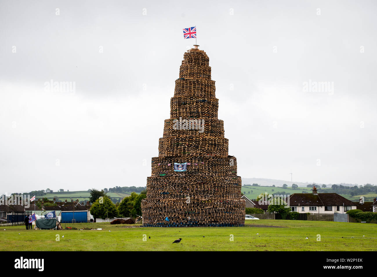 Craigyhill 11th night bonfire in Larne, Northern Ireland. Bonfires are traditionally lit in loyalist communities across Northern Ireland every year on July 11 to mark the anniversary of the Battle of the Boyne. Stock Photo