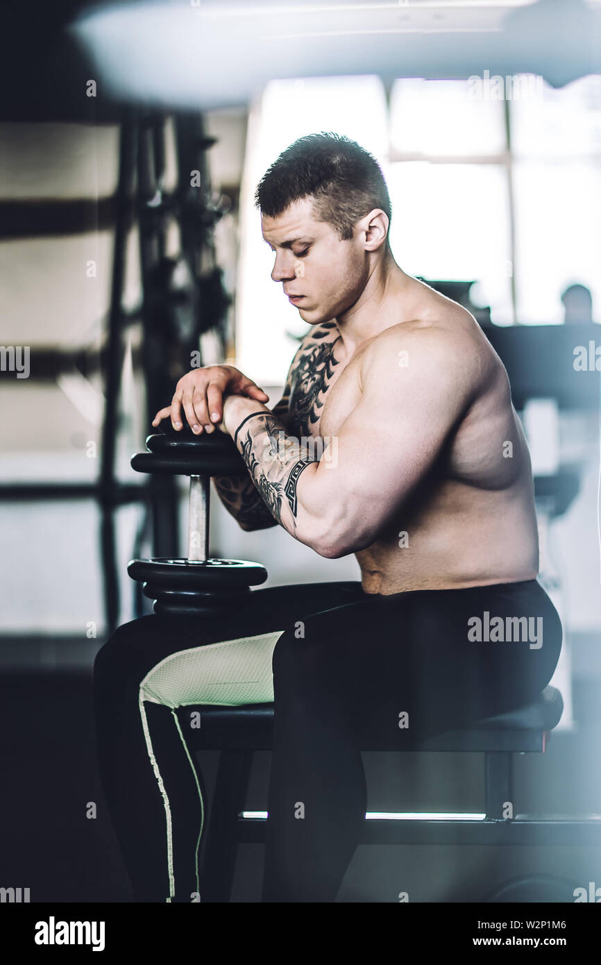 portrait of a brooding male bodybuilder in the gym . photo with copy ...