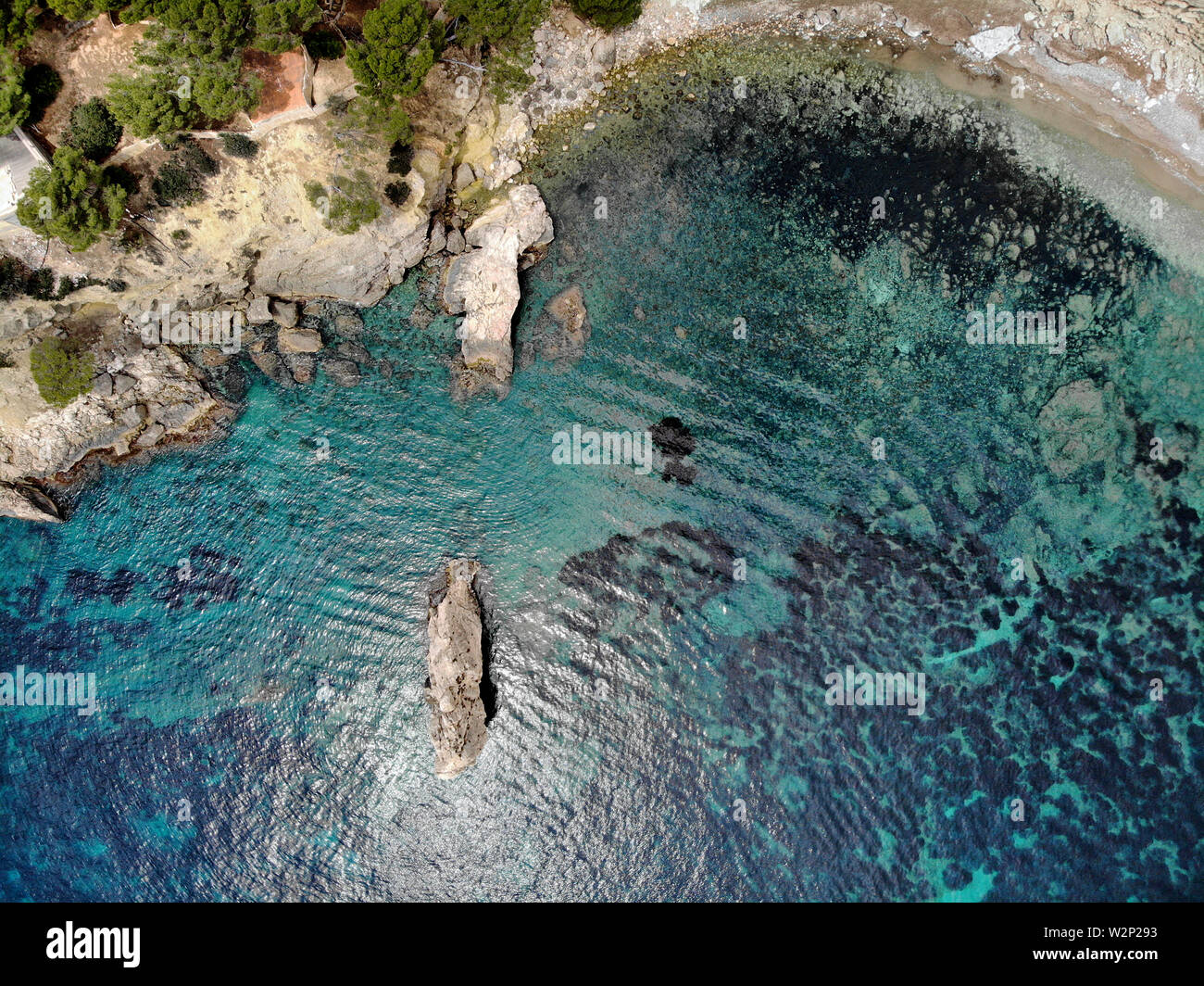 Cala en Cranc rocky seaside in the Palma de Majorca directly from above drone point of view photo, picturesque nature stony beach turquoise sea Stock Photo