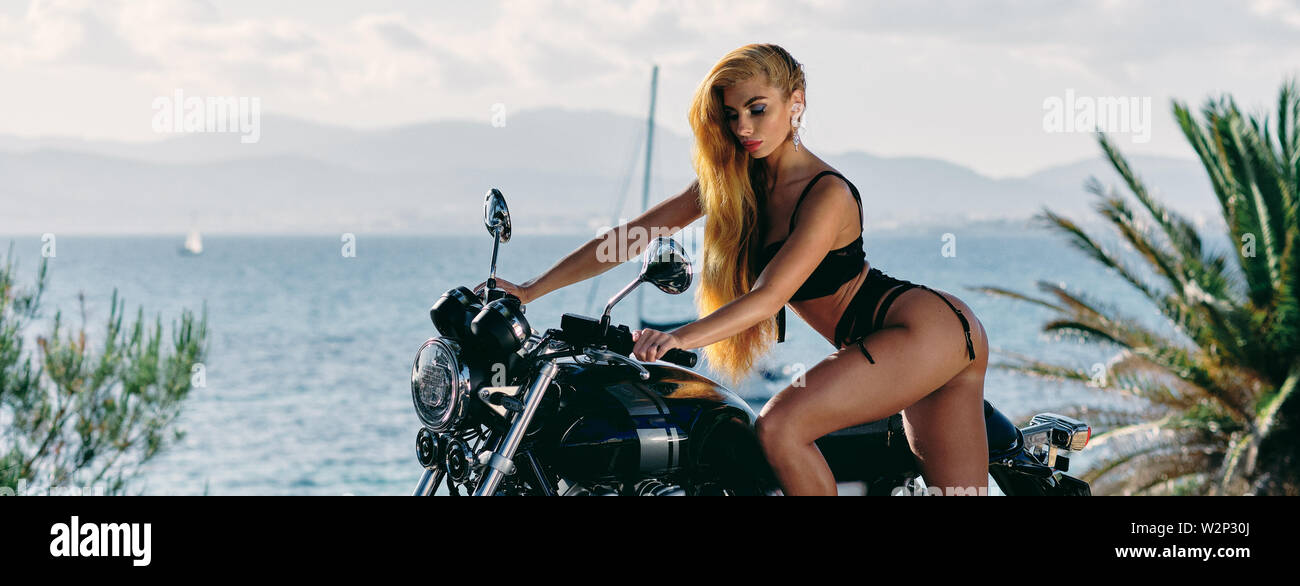 Panoramic view against Mediterranean Sea spanish tropical nature landscape  sexy european woman wearing black lingerie standing near motorcycle pose on  Stock Photo - Alamy