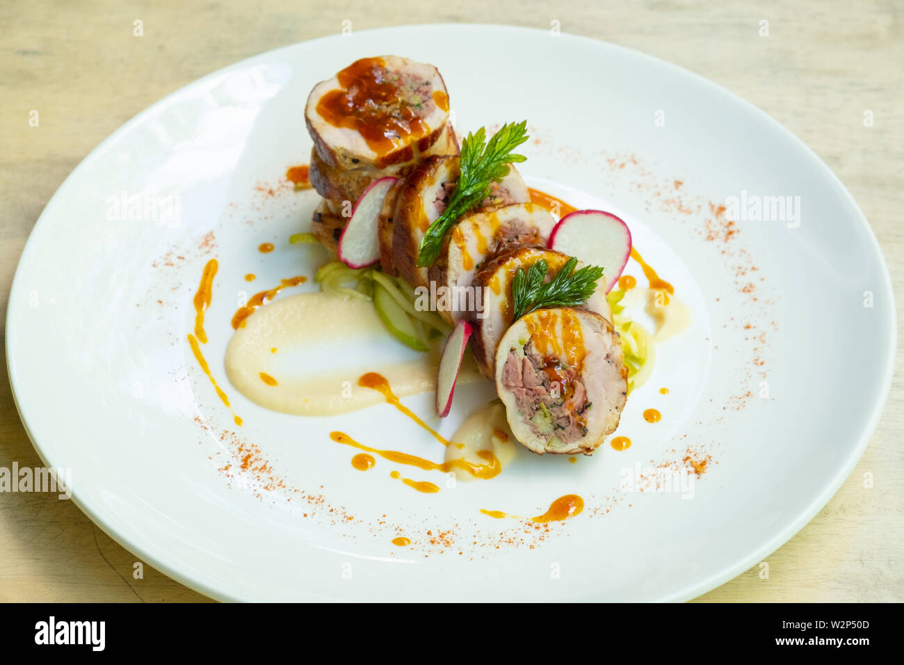 close up of a sliced stuffed pork loin roasted roll with sausage
