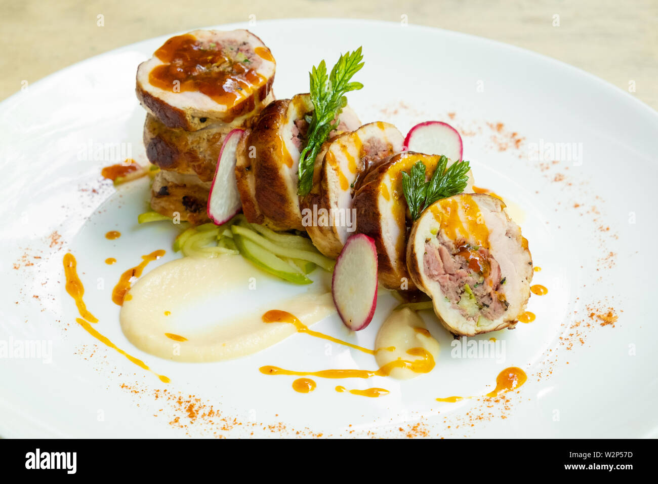 close up of a sliced stuffed pork loin roasted roll with sausage