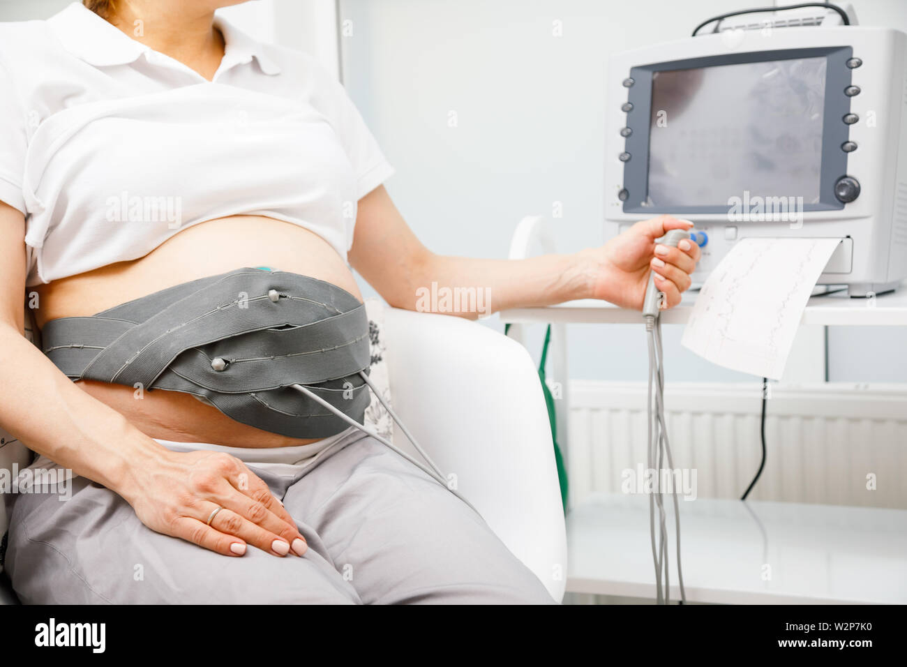 Pregnant Woman Sitting In Clinic Performing Cardiotocography CTG The 
