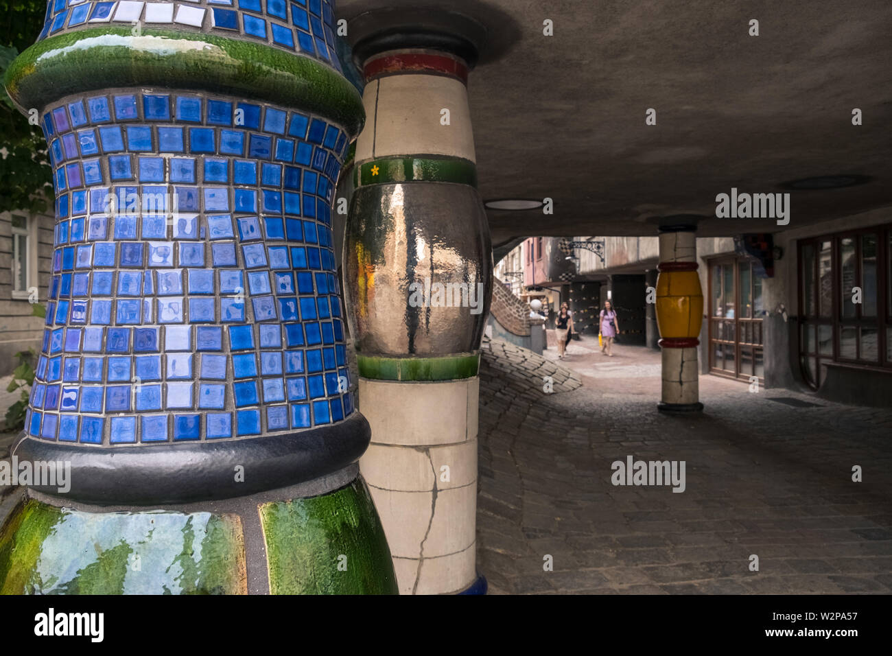 Tiled columns at Hundertwasserhaus, by architect Friedensreich Hundertwasser (a pseudonym), a local tourist attraction, Vienna, Austria. Stock Photo