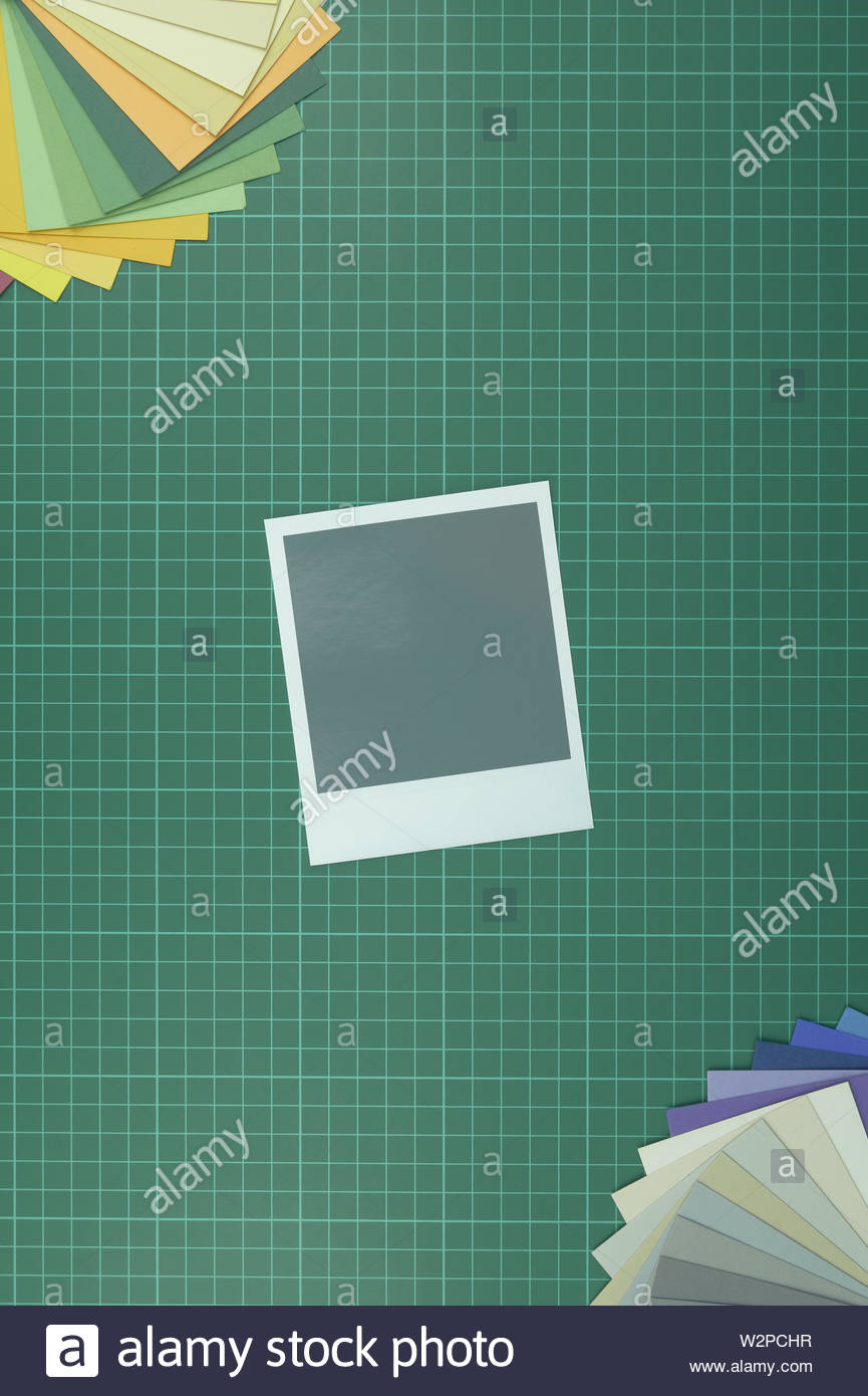 Top Down View Of Blank Instant Film Style Photograph On Cutting
