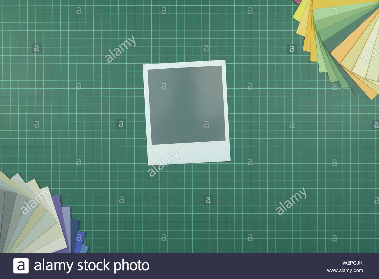 Top Down View Of Blank Instant Film Style Photograph On Cutting