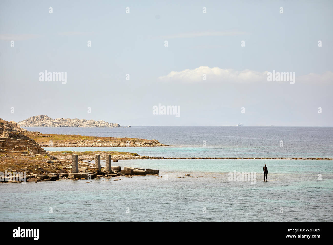Greek, Greece, Delos historical site island, archaeological ruins with Antony Gormley statues 6 Times Left 2009 in the sea Stock Photo
