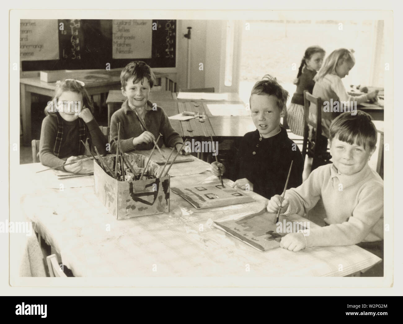 1950's happy primary school children painting, in classroom, dated June 1959, Mowmacre Primary School, Leicester, Leicestershire, U.K Stock Photo