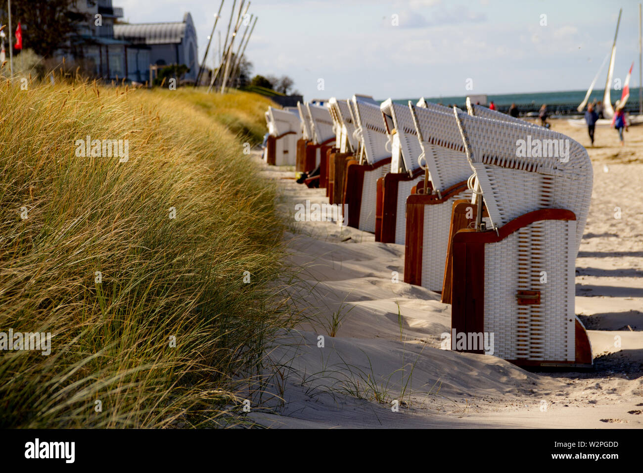 Tourist Location at the beach. Baltic sea beach summer day. Beautifil White beach at the Baltic sea in Germany. Blue cloudy sky in the Background. Stock Photo