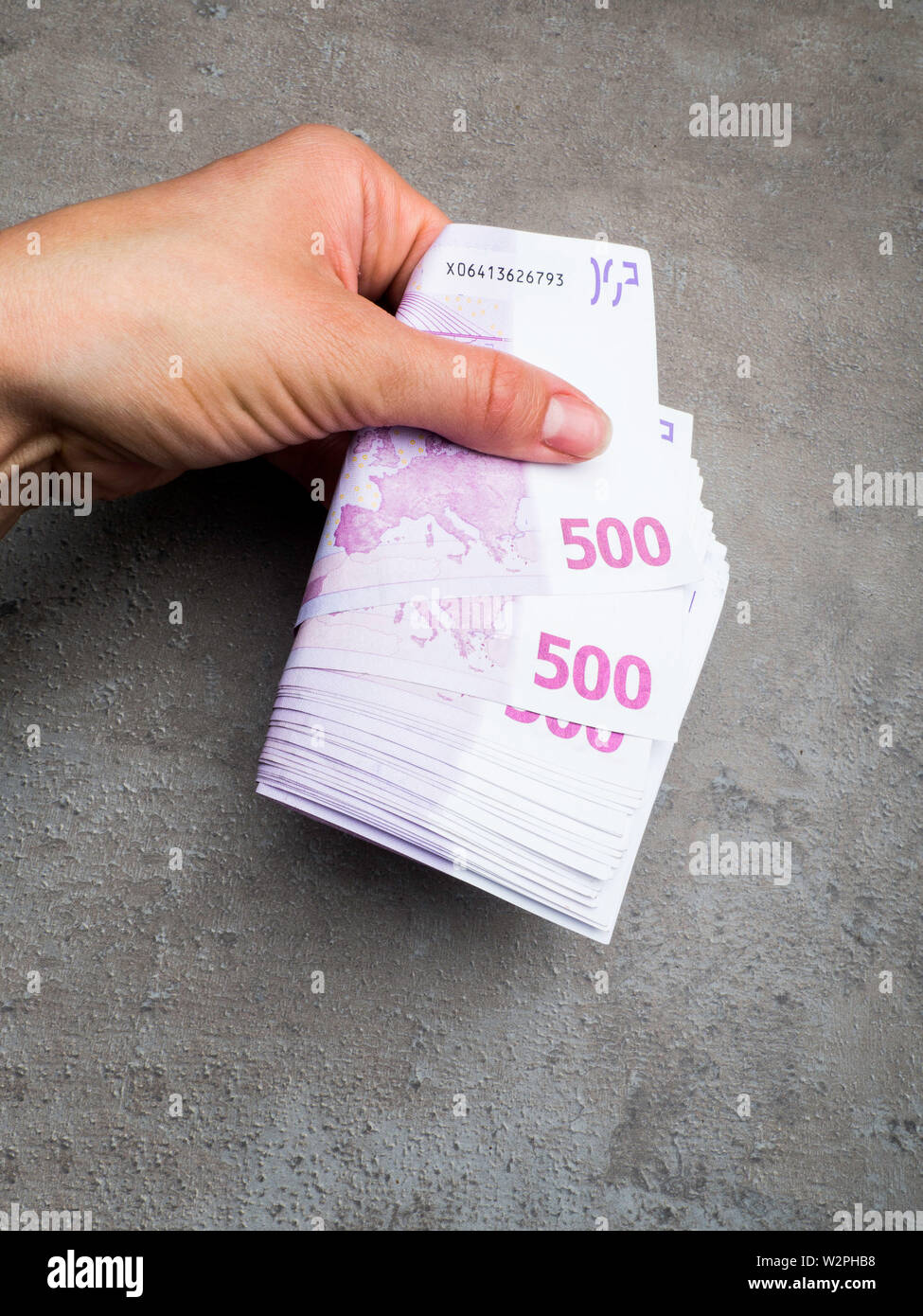 hand giving 500 euro banknotes isolated on grey, Business and Finances  concept. Cash Money. Woman holding euros money banknotes Stock Photo - Alamy