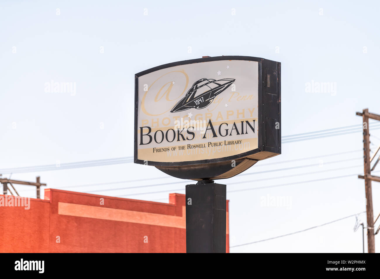 Roswell, USA - June 8, 2019: Main street road sign in New Mexico famous city for alien sightings for store shop for used books Stock Photo