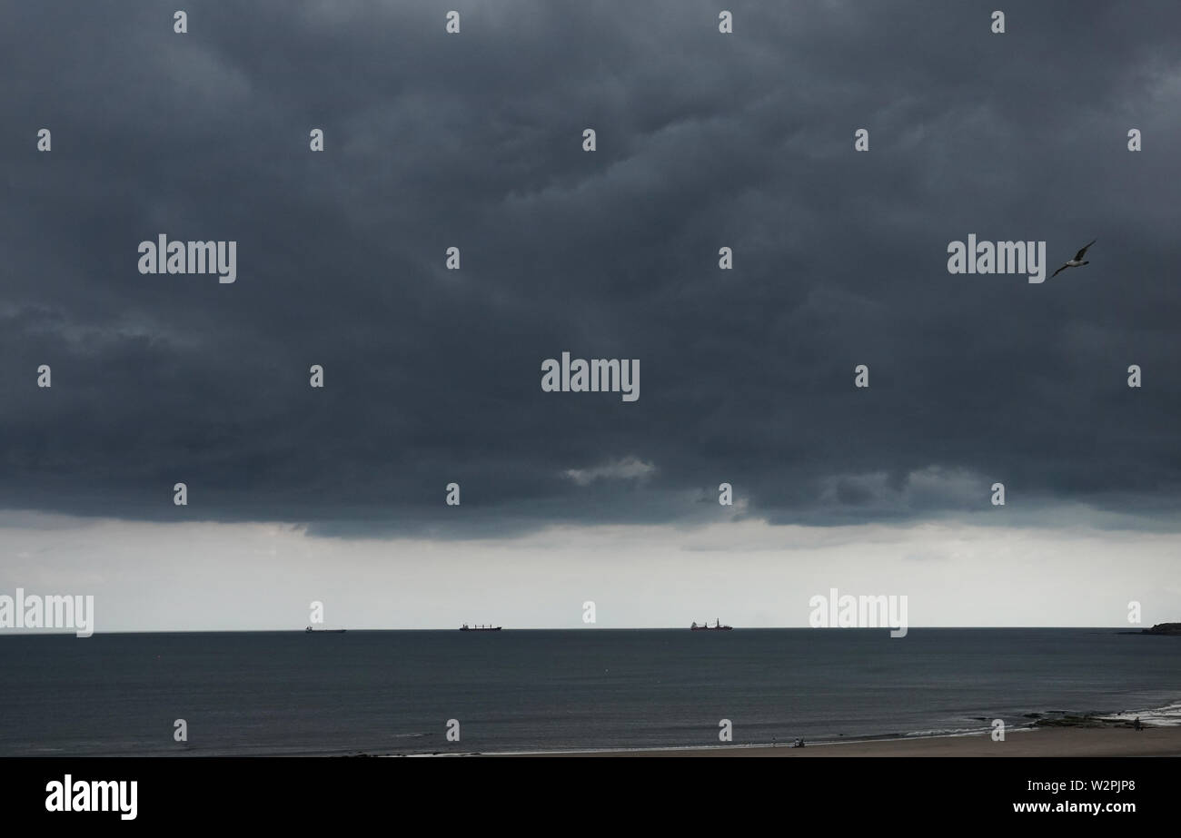 Storm clouds over Whitley bay beach with thunder and lightening storms forecast. Stock Photo