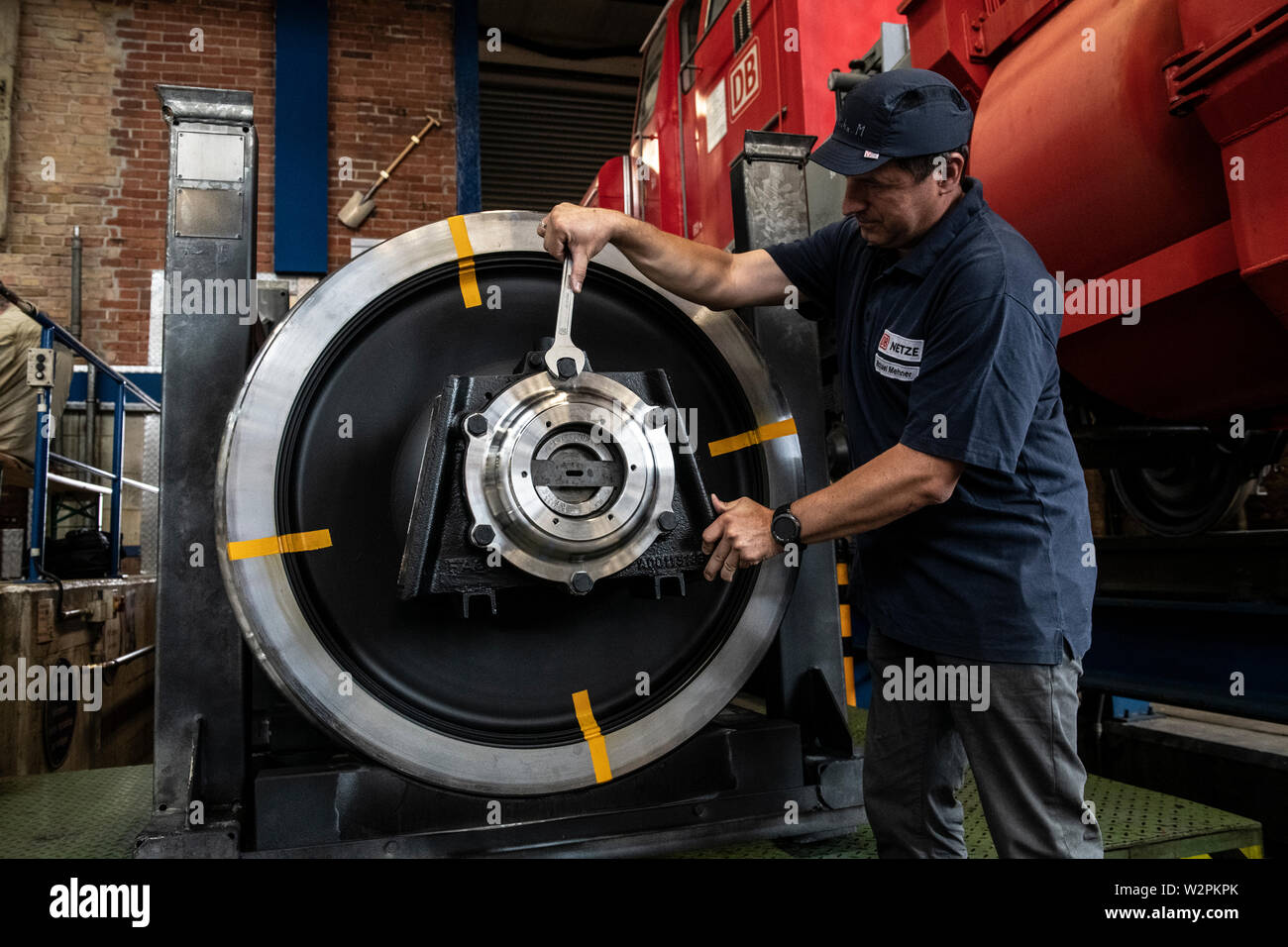 Berlin, Germany. 10th July, 2019. A Deutsche Bahn employee tightens a screw on a component produced in a 3D printer at a press event. Deutsche Bahn now also uses 3D printing for metal parts relevant to its operations. About five percent of all spare parts are to be produced in this way by the suppliers in the future, the Bahn announced in Berlin. Credit: Paul Zinken/dpa/Alamy Live News Stock Photo