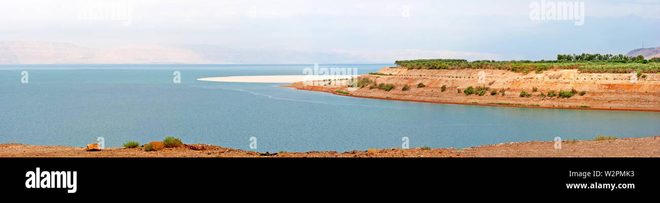 Dead Sea coastline landscape with wild salty shore and mountains at sunny day in Jordan. Stock Photo