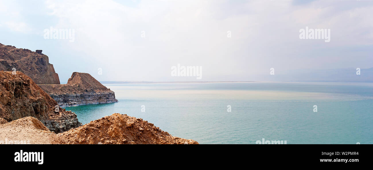 Dead Sea coastline landscape with wild salty shore and mountains at sunny day in Jordan. Stock Photo