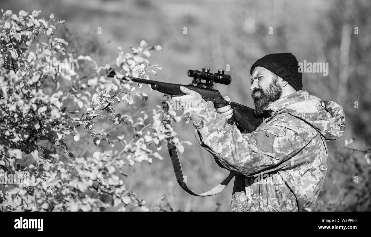 Man hunter with rifle gun. Boot camp. Hunting skills and weapon equipment. How turn hunting into hobby. Military uniform fashion. Bearded man hunter. Army forces. Camouflage. antiterrorist operation. Stock Photo