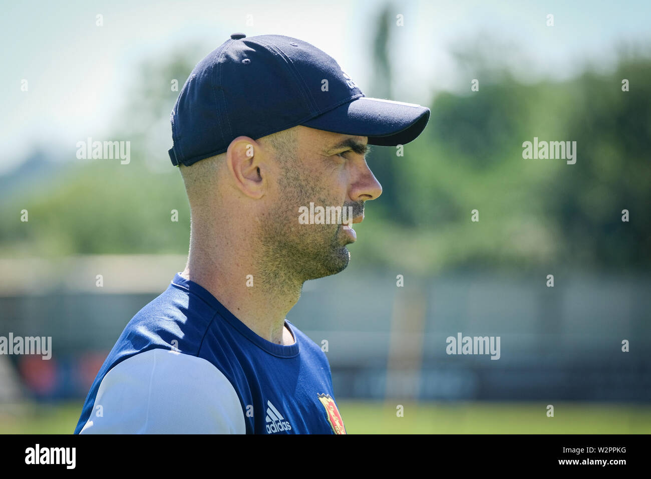Cris the trainer of Mont d'Or Azergues (Chasselay, Rhône, France) in  profile with a cap supervises the training Stock Photo - Alamy