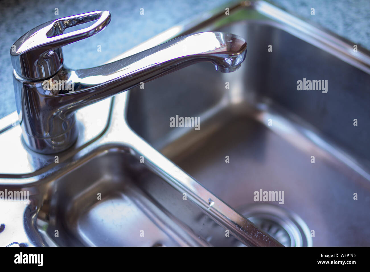 Kitchen sink Concept. Clean Chrome sink in a modern kitchen with copy