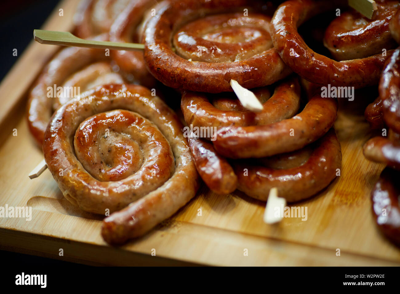 Rolled up round pork sausage  party food Stock Photo