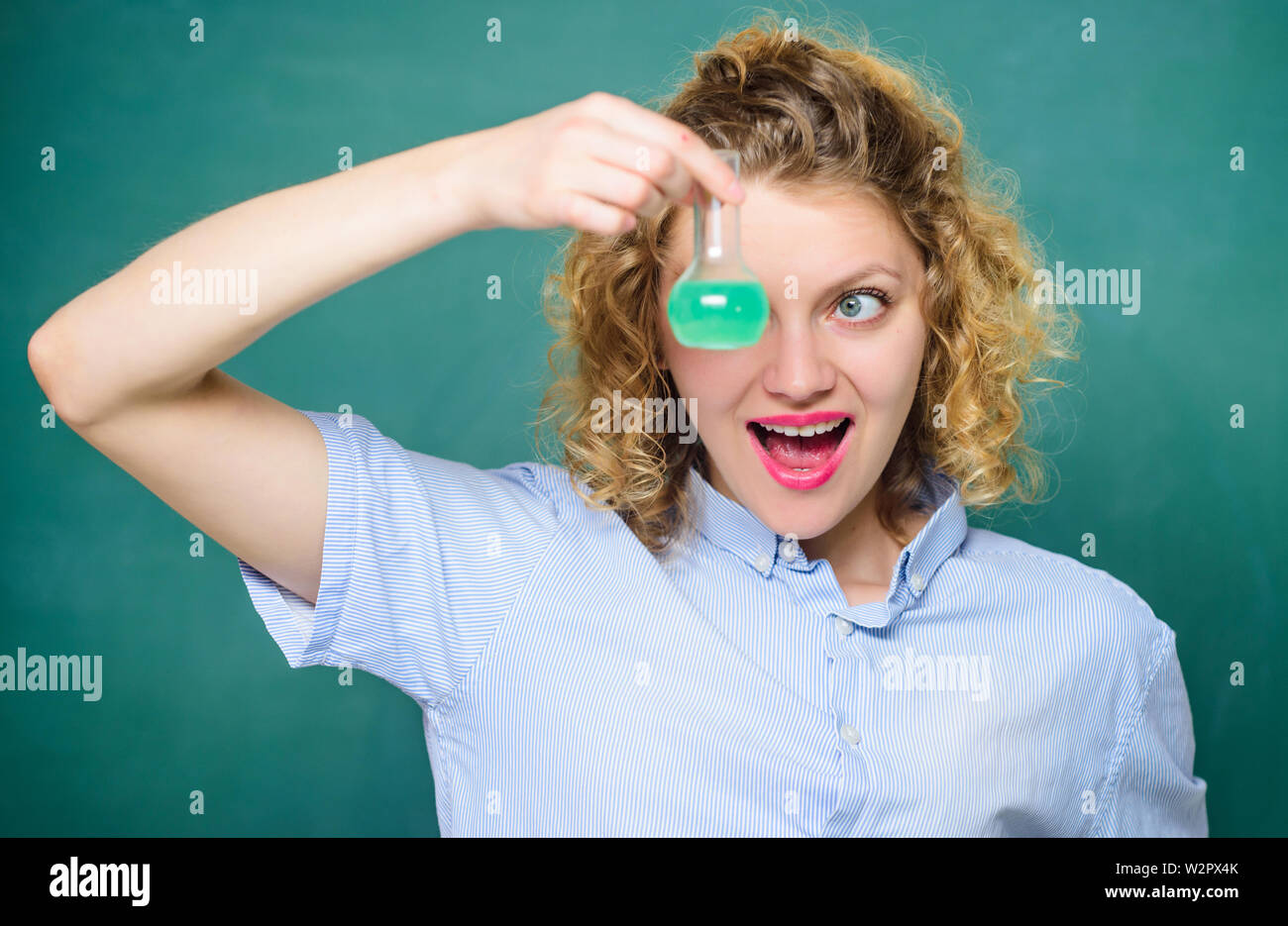 Science and education. girl hold chemical flask with liquid. happy student with beaker. biology experiment. sample formula. chemistry research results. scientist at school lab. school lesson. Stock Photo