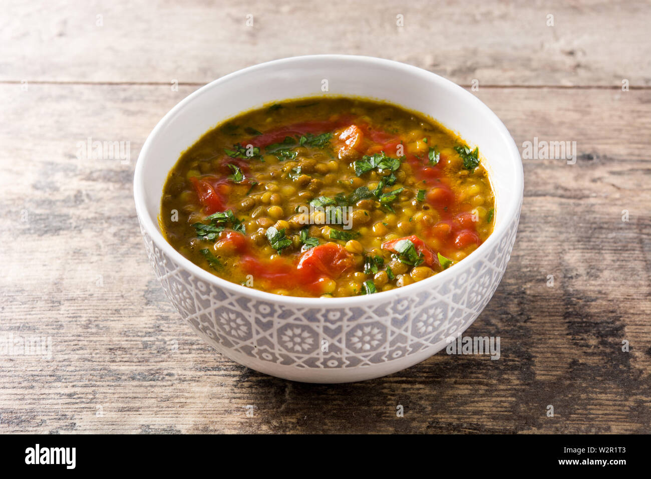Indian lentil soup dal (dhal) in a bowl on wooden table Stock Photo - Alamy