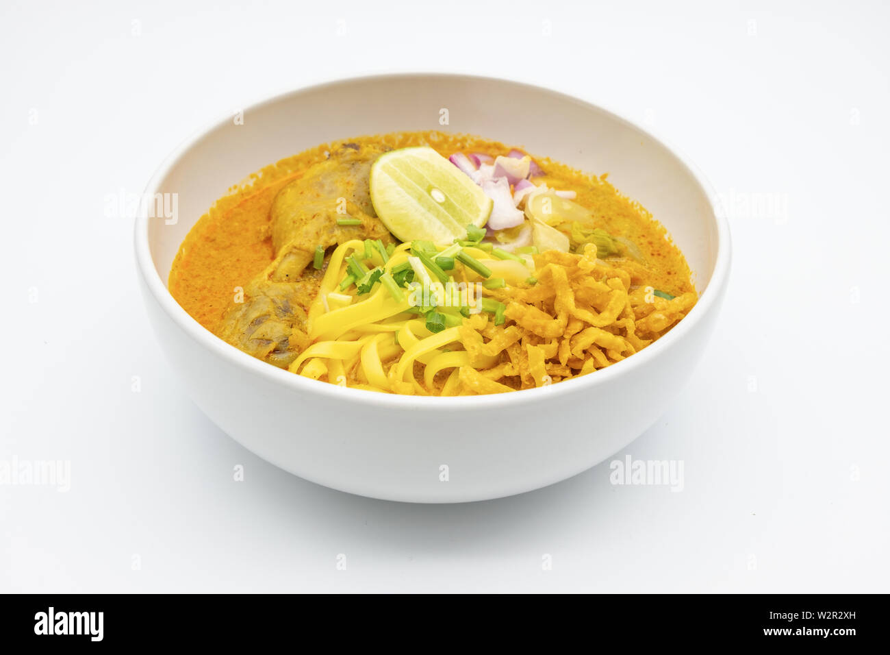 KhaoSoi, Thai Northern Curry Noddle Soup with chicken, Thai traditional food, Northern style on the wooden table Stock Photo