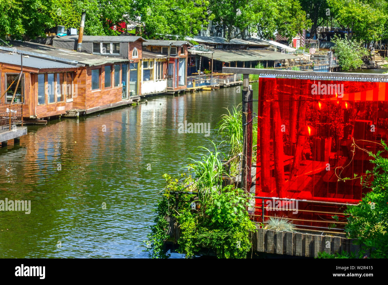 Berlin Spree river, houseboats, and restaurants in Spree canal, Flutgraben water canal, Kreuzberg Germany Stock Photo