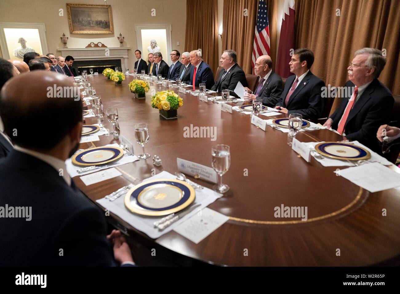 U.S President Donald Trump, joined by Vice President Mike Pence and Cabinet members, participate in an expanded working luncheon with the Emir of Qatar, Tamin bin Hamad Al Thani and delegates at the Cabinet Room of the White House July 9, 2019 in Washington, DC. Stock Photo