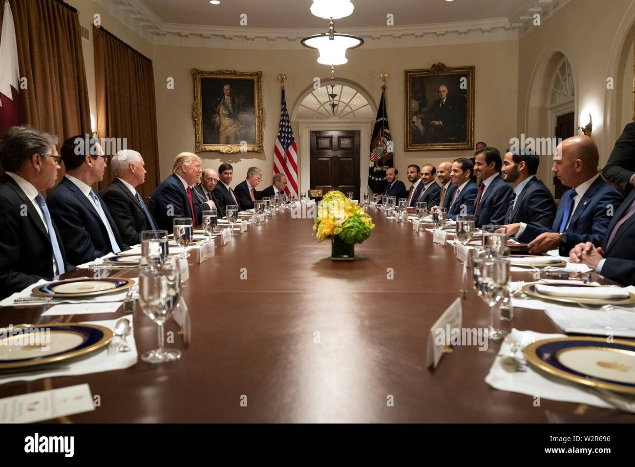 U.S President Donald Trump, joined by Vice President Mike Pence and Cabinet members, participate in an expanded working luncheon with the Emir of Qatar, Tamin bin Hamad Al Thani and delegates at the Cabinet Room of the White House July 9, 2019 in Washington, DC. Stock Photo