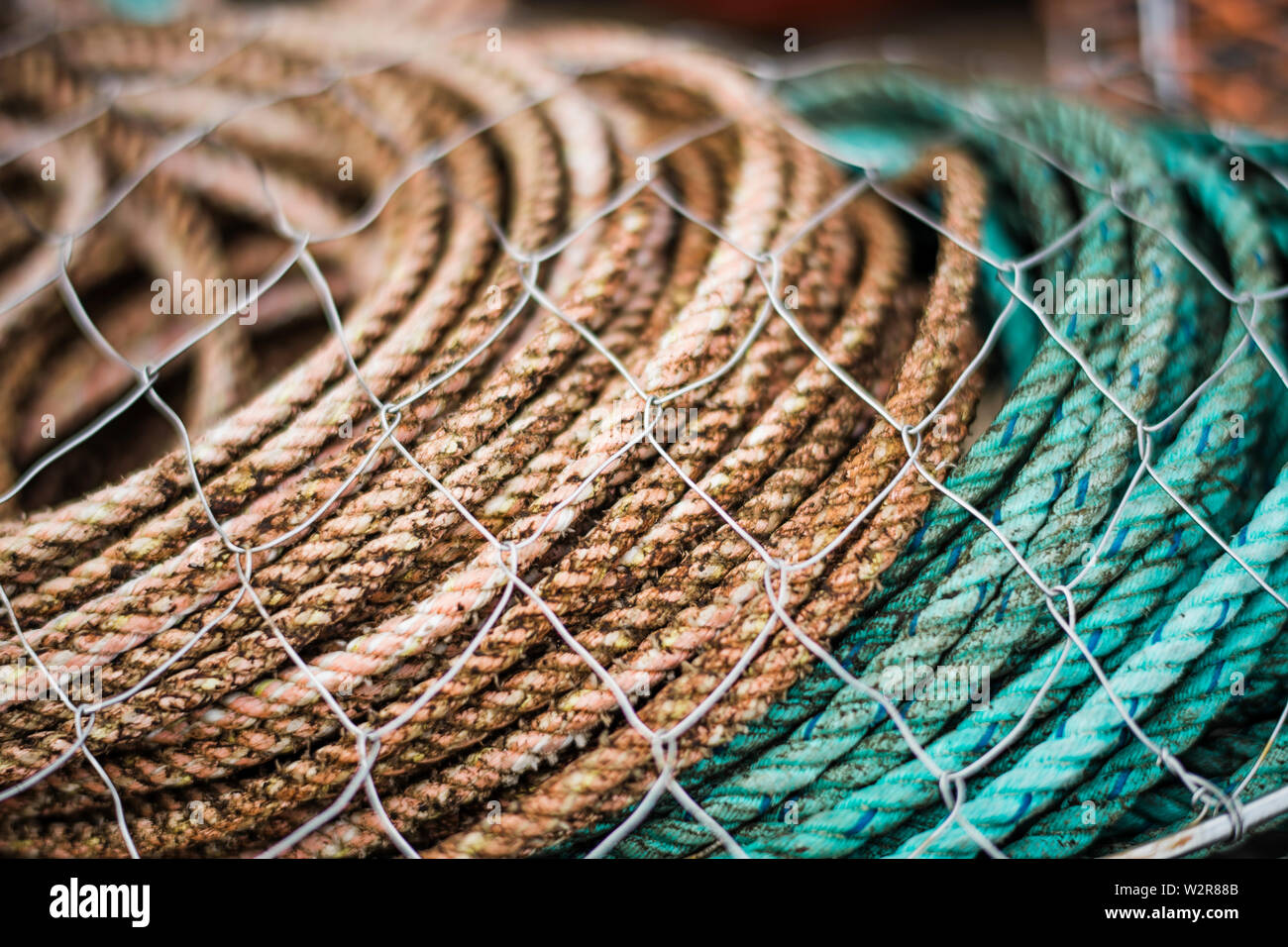 Fishing gear, rope and nets stacked up Stock Photo - Alamy