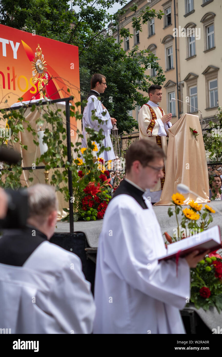 Feast of Corpus Christi procession taking place in the streets of Krakow old town, Poland Stock Photo