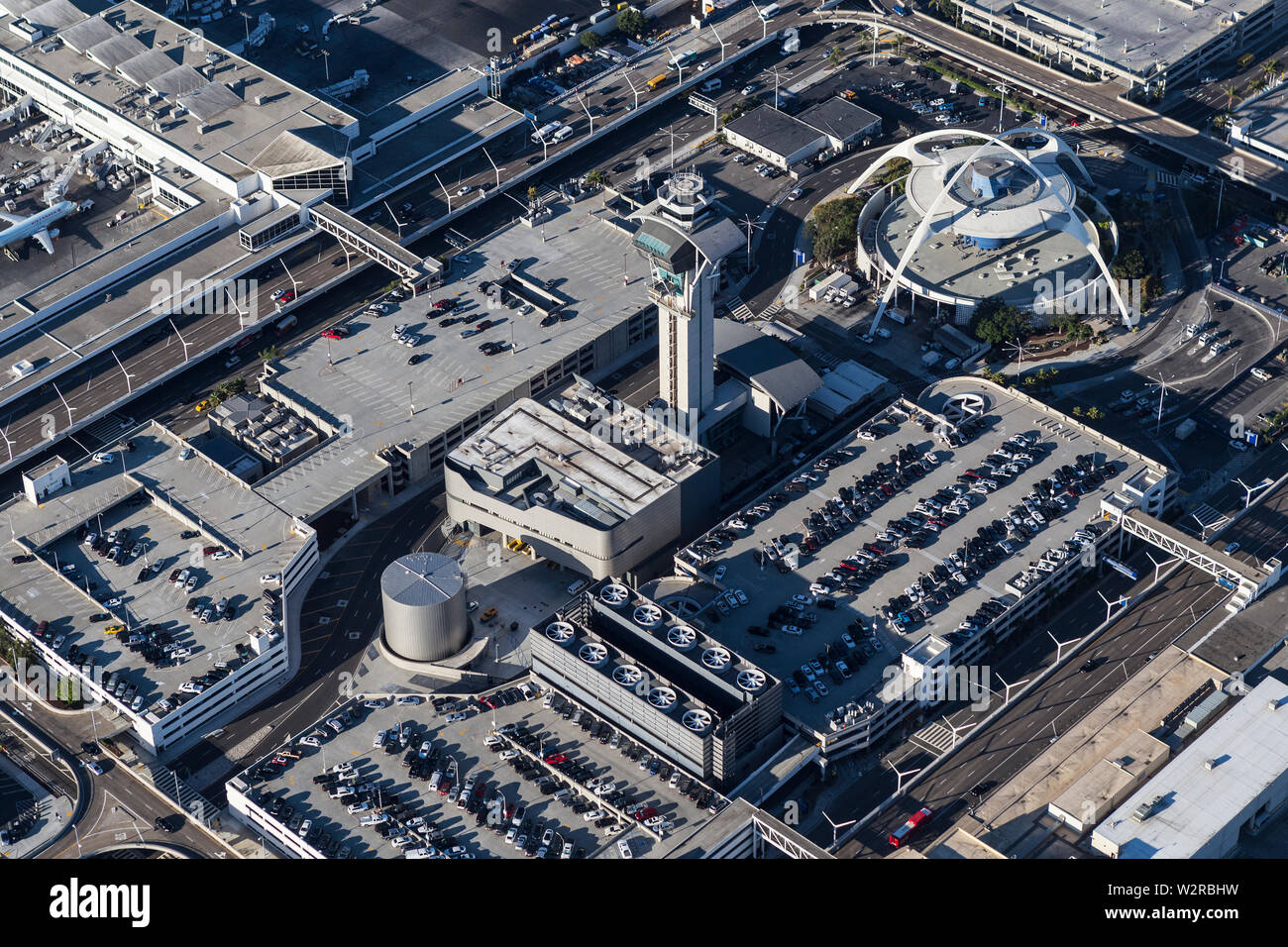 Los Angeles, California, USA - August 16, 2016:  Aerial view of short term parking garages, roads, control tower and modernist theme building. Stock Photo