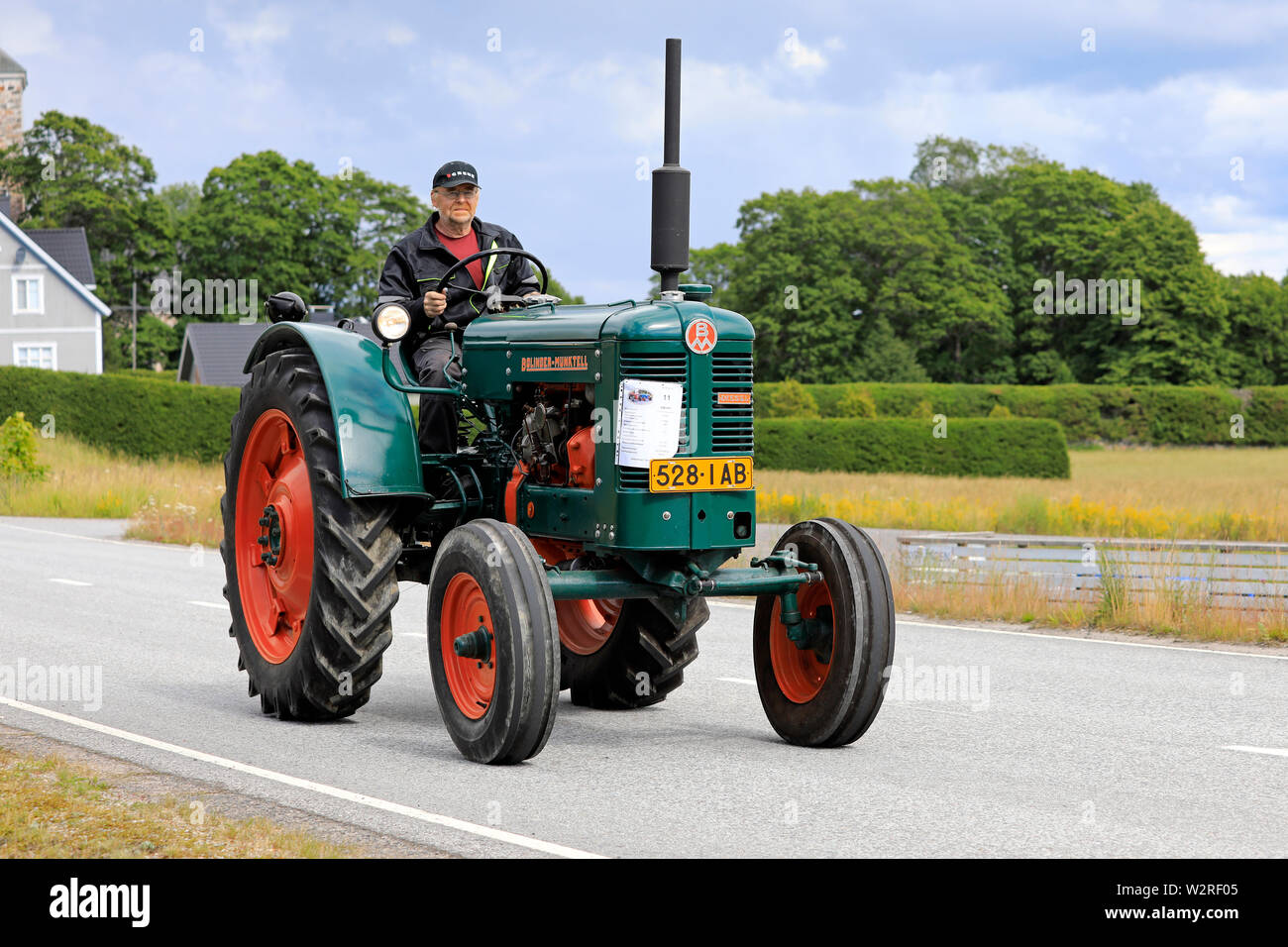 Kimito, Finland. July 6, 2019. Bolinder-Munktell tractor year 1956 and driver on Kimito Traktorkavalkad, annual vintage tractor show and parade. Stock Photo