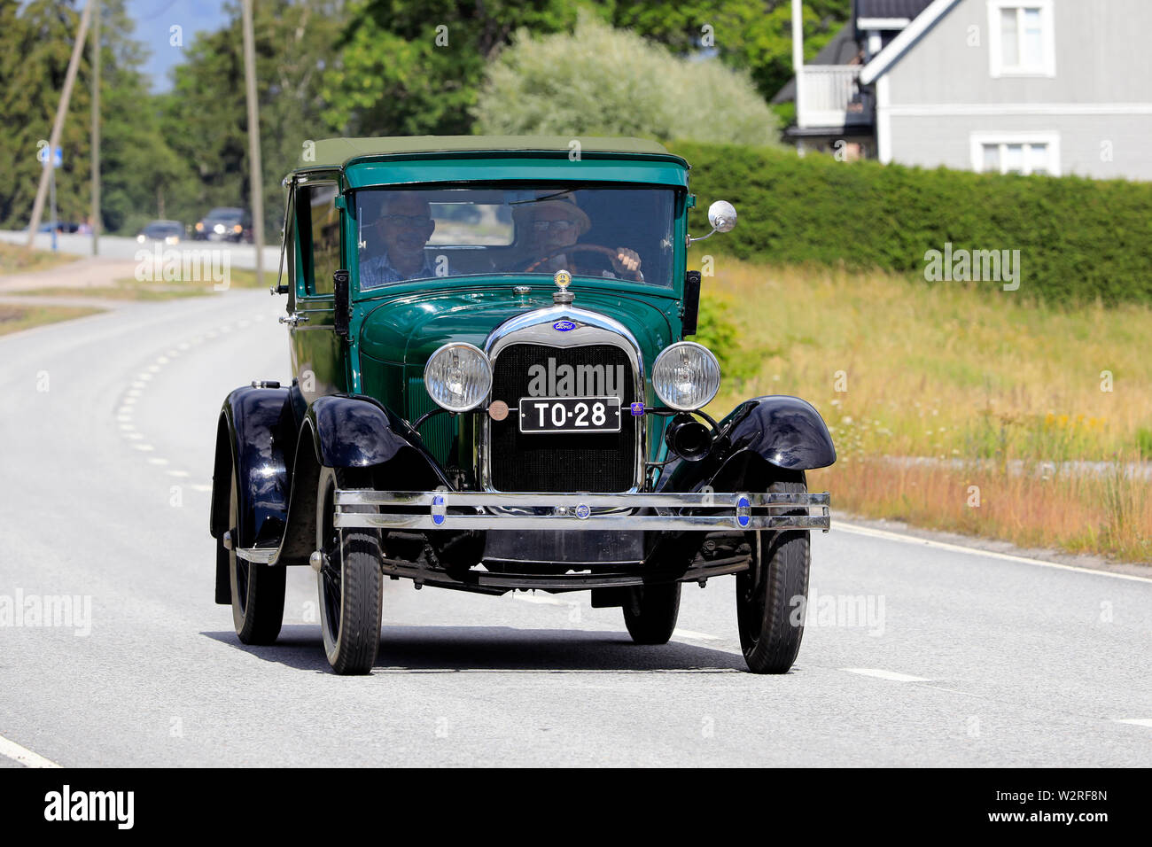 Finland. July 6, 2019. Kimito Tractorkavalkad 2019, vintage tractor parade featured also antique cars, here green Ford Model A on the road. Stock Photo