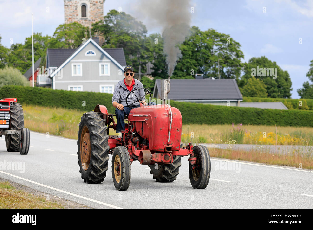 Kimito, Finland. July 6, 2019. Young man drives classic Porsche-Diesel Super Tractor on Kimito Tractorkavalkad, annual vintage tractor show and parade Stock Photo