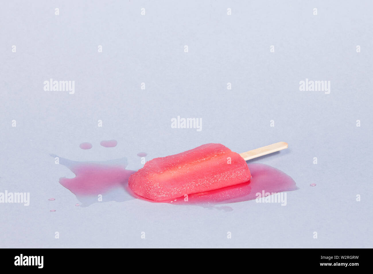 Pink Melting Popsicle in a Blue Background Stock Photo