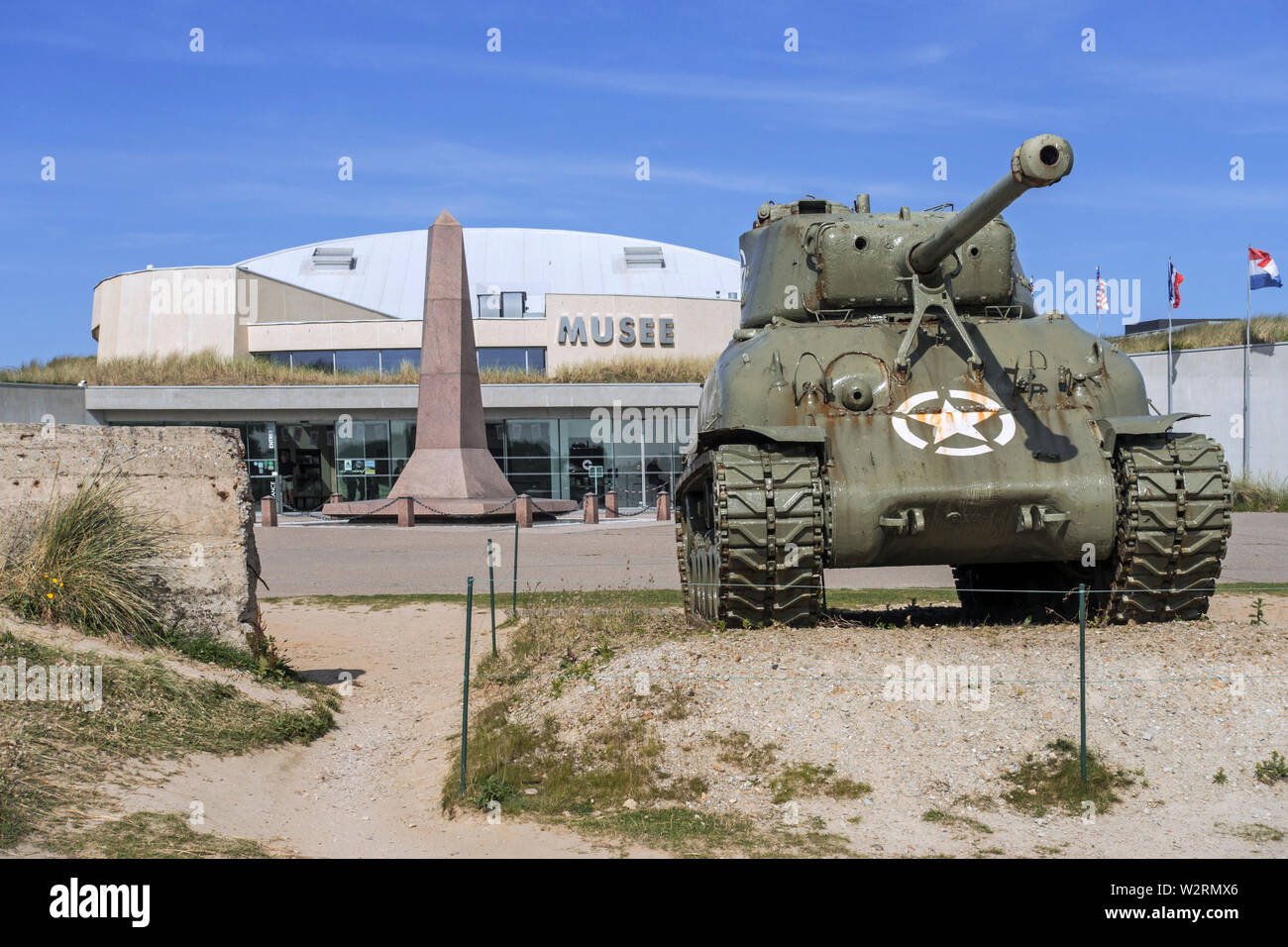 American M4 Sherman tank in front of the Musée du Débarquement Utah Beach, World War Two museum at Sainte-Marie-du-Mont, Normandy, France Stock Photo