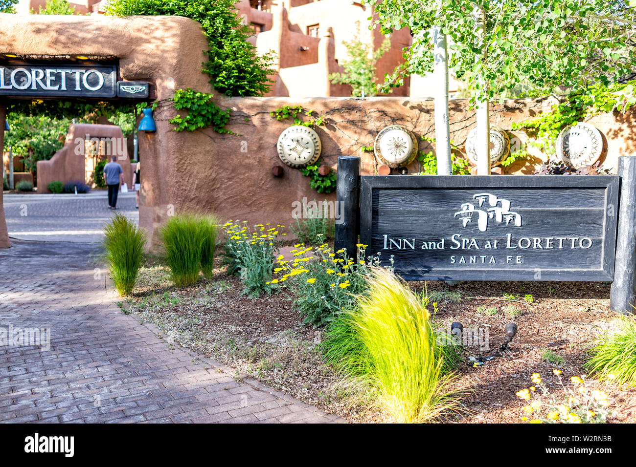 Santa Fe, USA - June 14, 2019: Old town downtown in United States New Mexico city with adobe pueblan style architecture and sign for inn and spa at Lo Stock Photo