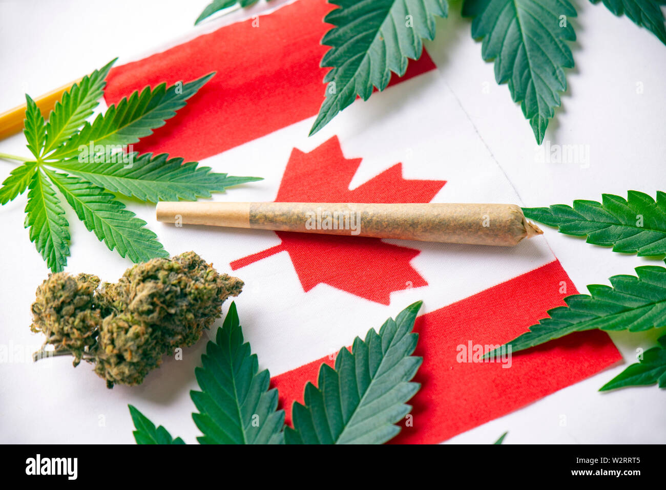 Detail of canadian flag with cannabis leaves, joint and dried marijuana